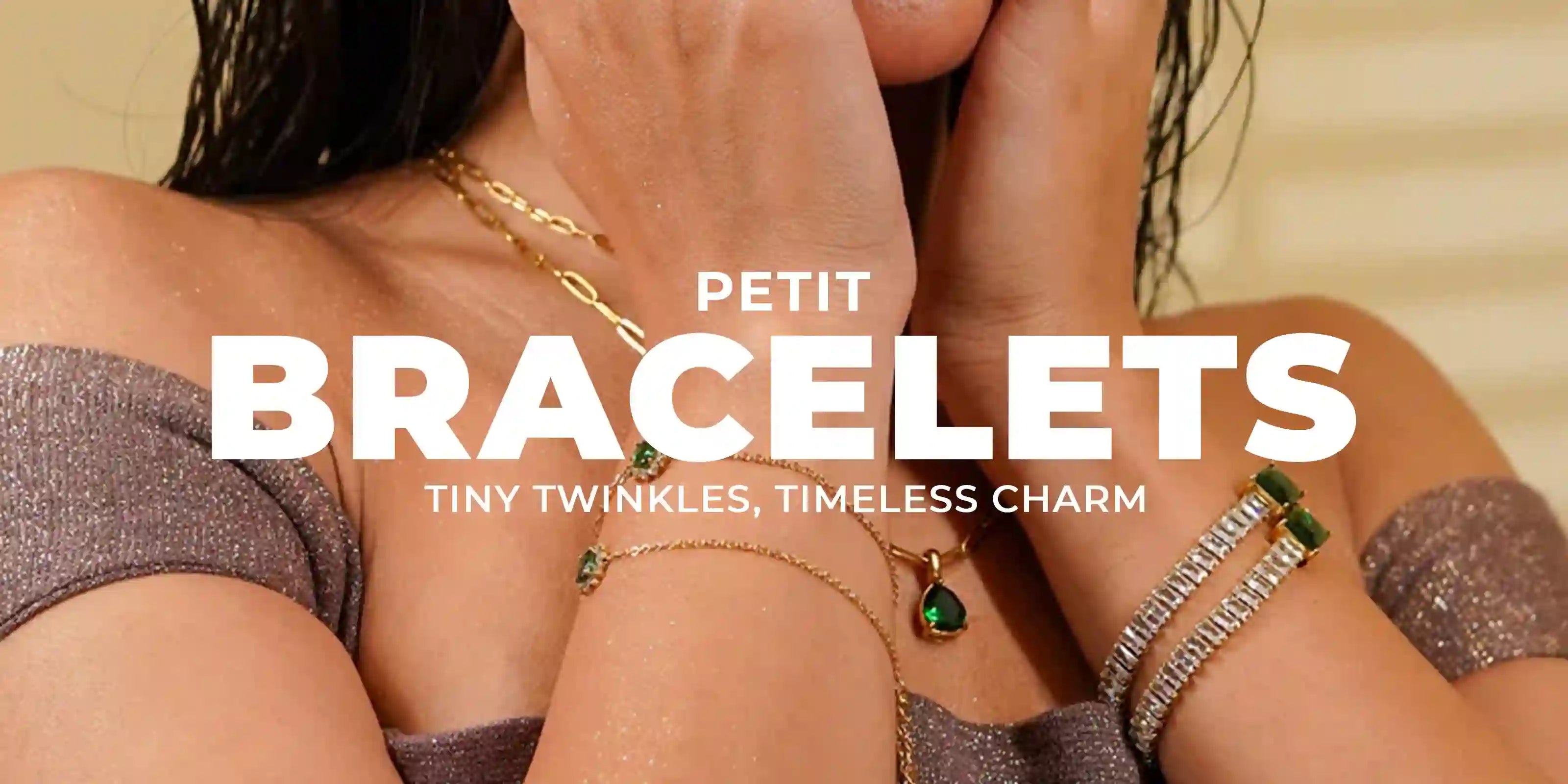 Woman wearing 18k Gold Plated Petit Bracelets with green gemstone charms and sparkly silver bracelets
