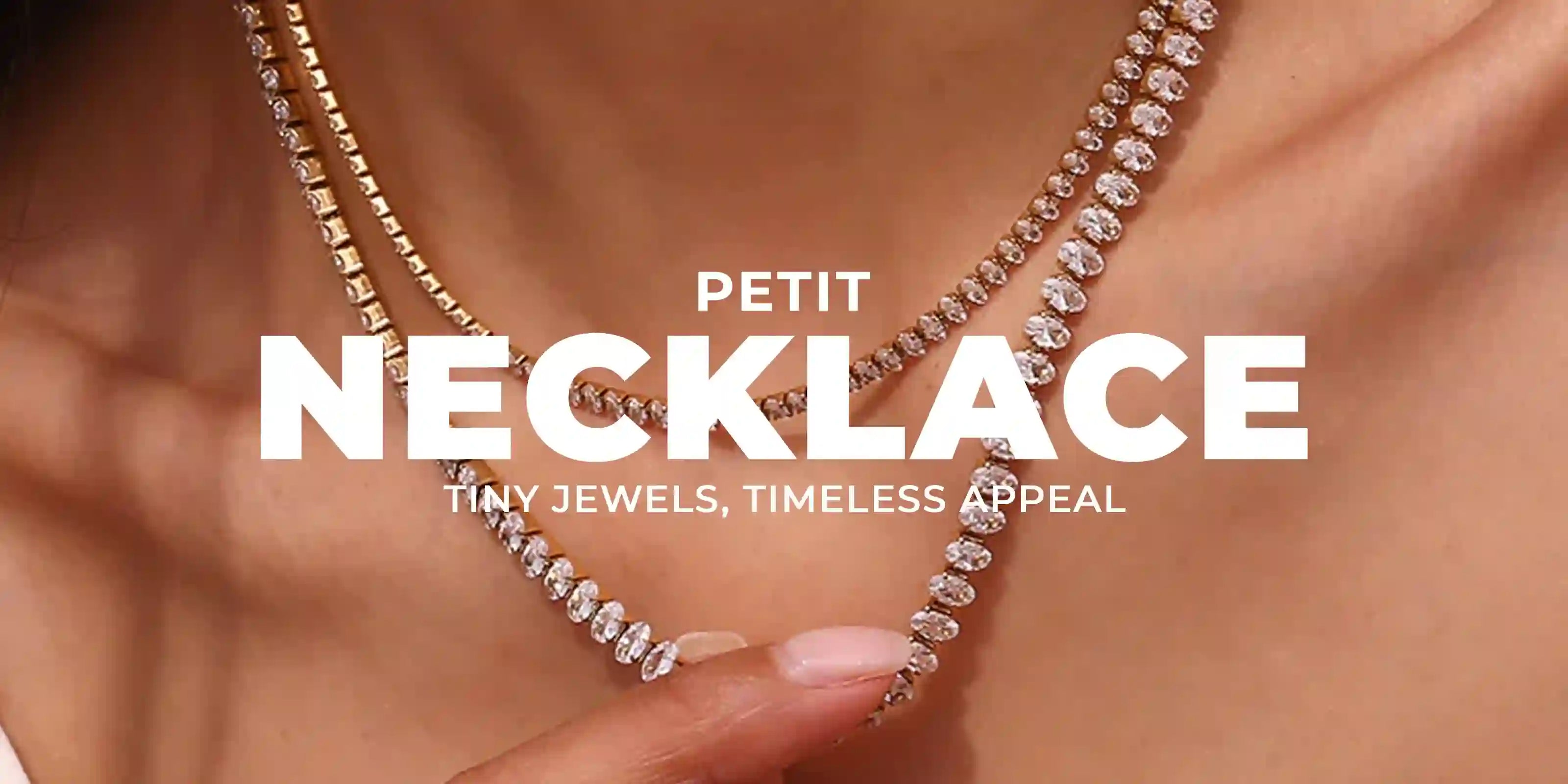 Woman wearing 18k Gold Plated Petit Necklace, layering sparkling crystal chains