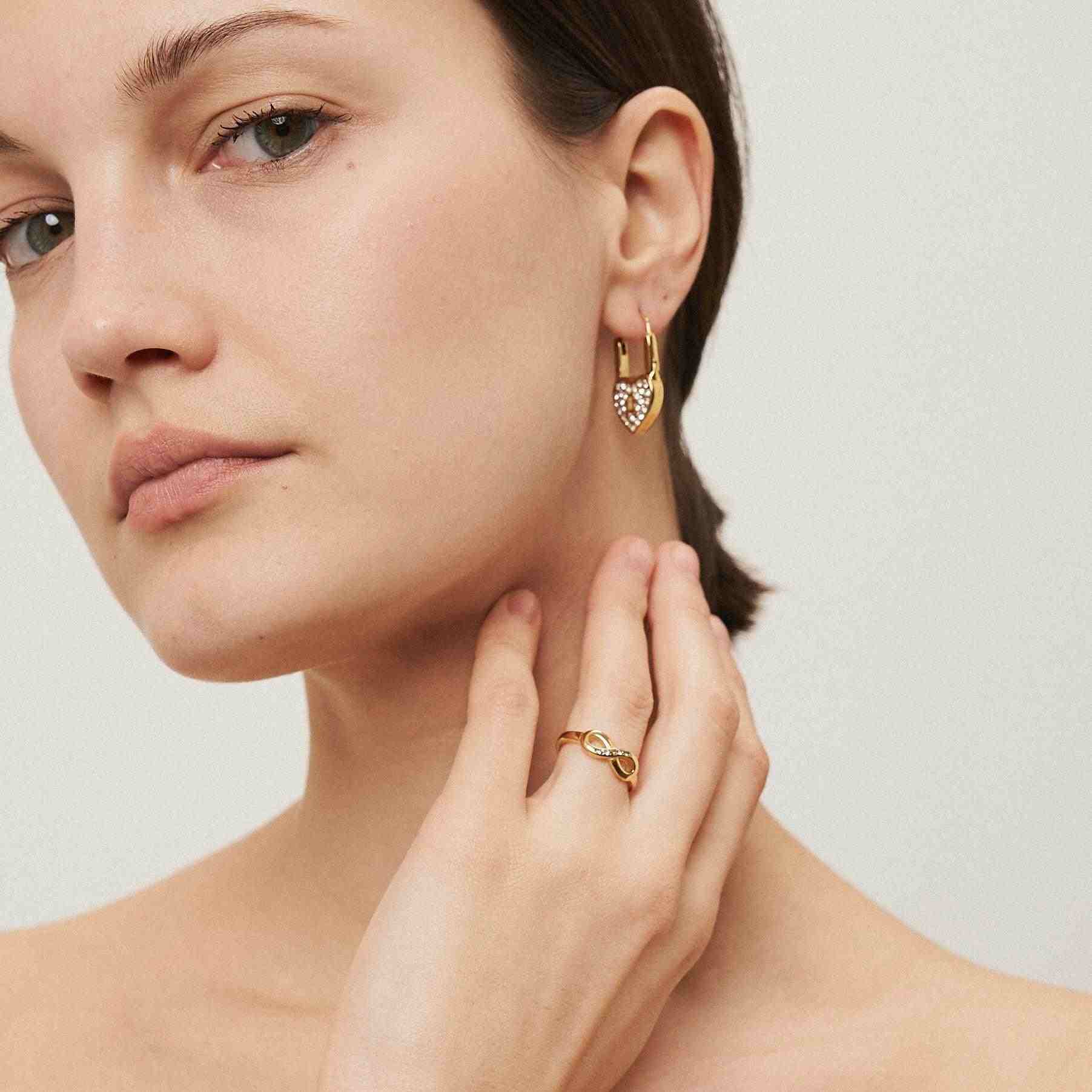 Girl wearing 18k Gold Plated Earring and ring. Shop at Mithra and Co.