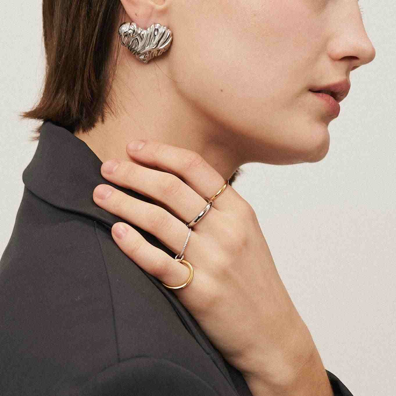 Wearing gold and silverrings. Shop Online.