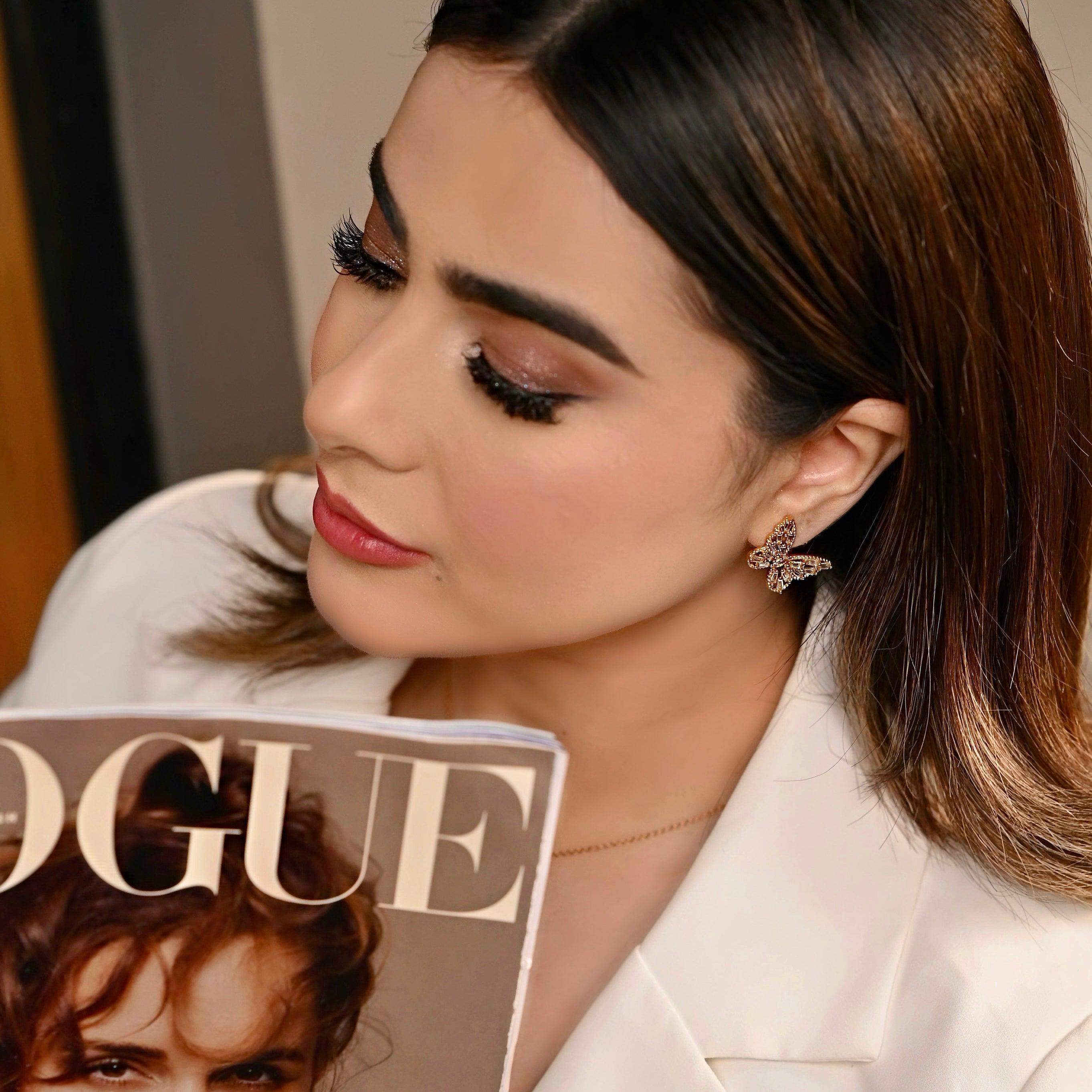 Girl wearing Enchanted Flutter - 18k Gold Plated Butterfly Earrings Studs. Buy Now at Mithra and Co.