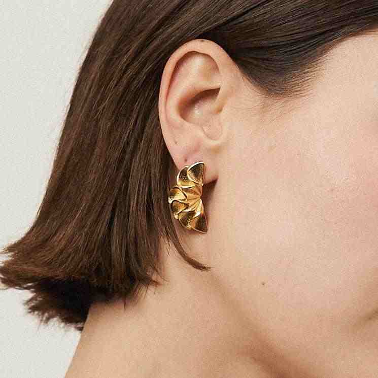 Wearing 18k gold plated Flora Earrings.