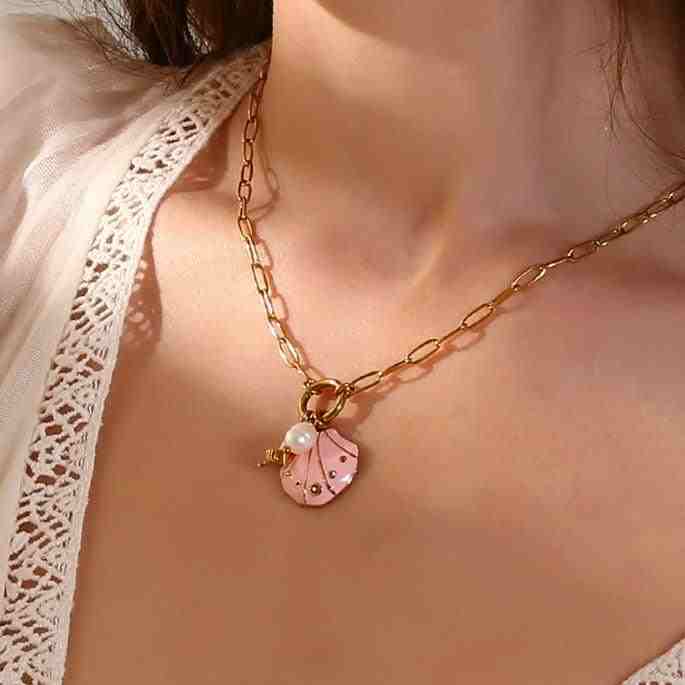 Wearing 18k gold plated Beach Seashell Necklace Charm - Coastal Essence. Buy Online.