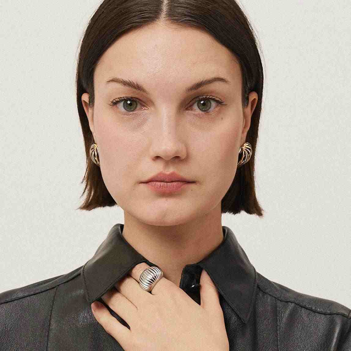 Wearing Silver plated Earrings. Buy Heart in a cage Online at Mithra and Co.