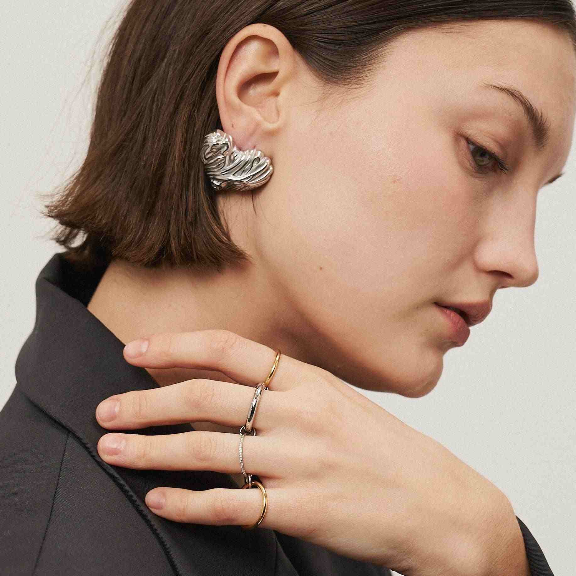 Wearing gold and silver stack rings. Shop Now.