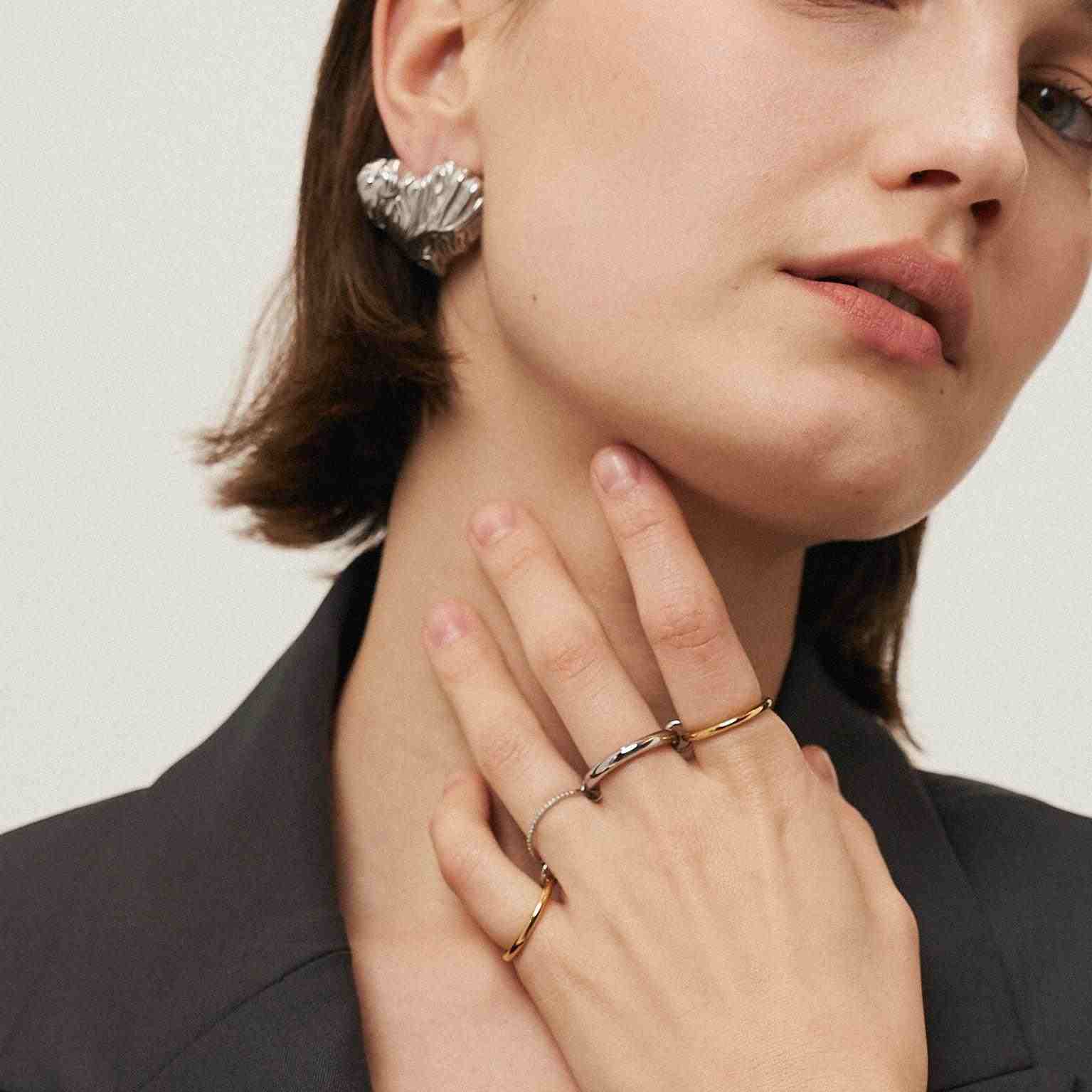 Wearing gold and silver Timeless stack rings. Shop at MIthra and Co.