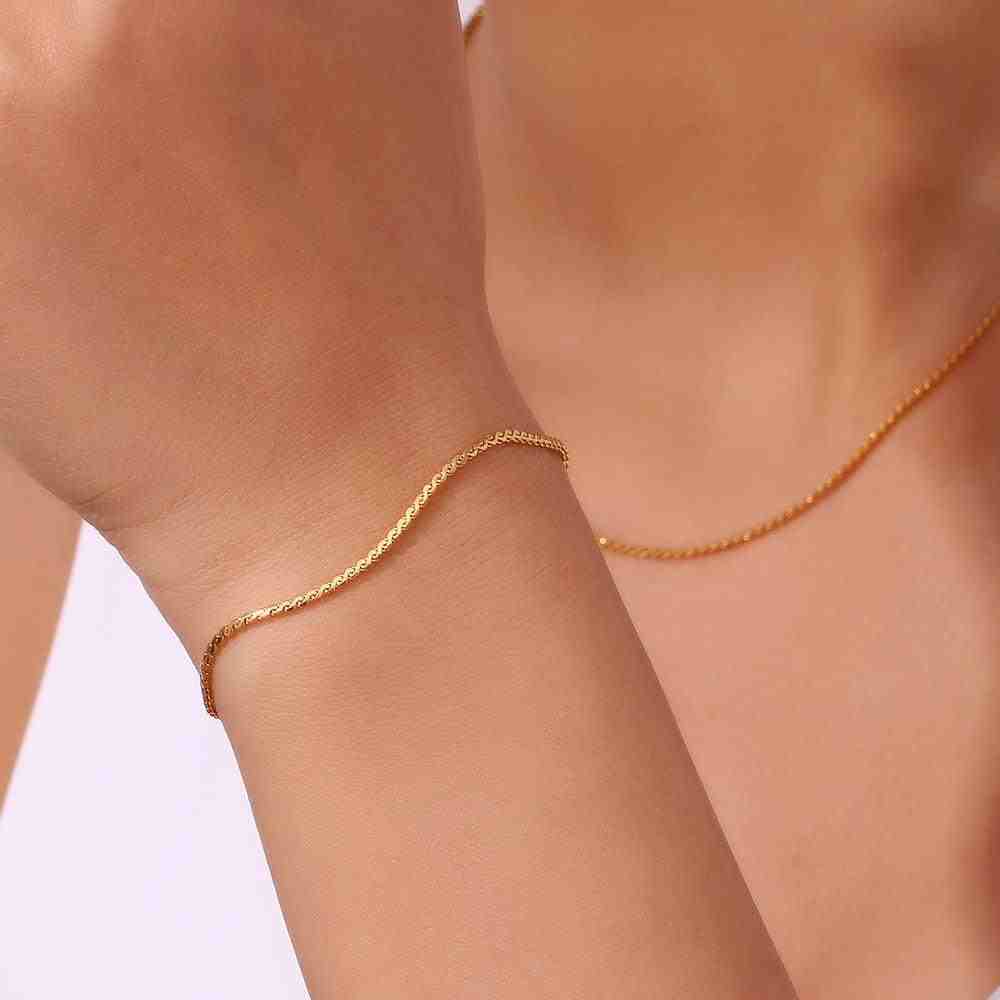 Wearing 18k Gold Plated thin S Chain Bracelet and necklace - Cici. Buy at Mithra and Co.