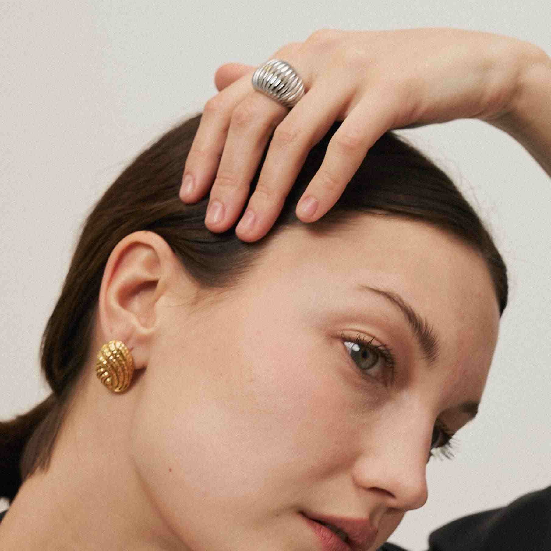 Girl wearing Gold Plated Knot Studs - Knotique Earrings. Buy Online at Mithra and Co.