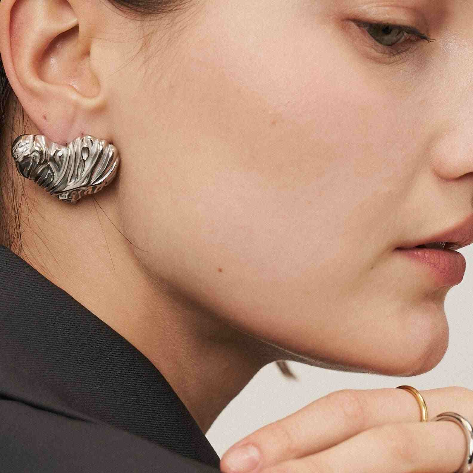 Girl wearing Silver Plated stud earrings. Buy Online at Mithra and Co.