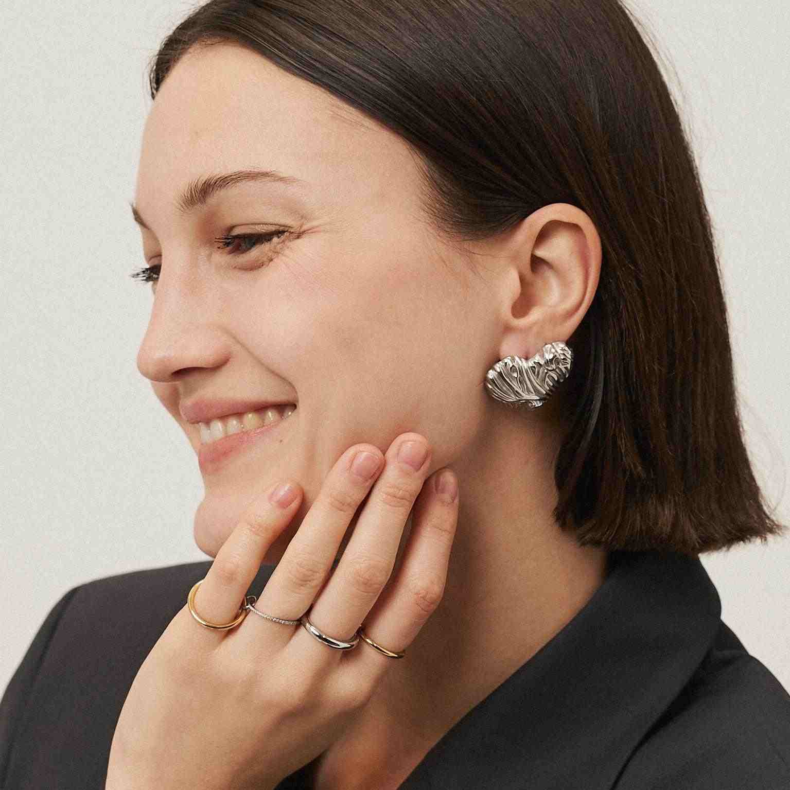 Wearing gold and silver stack rings. Shop Online.