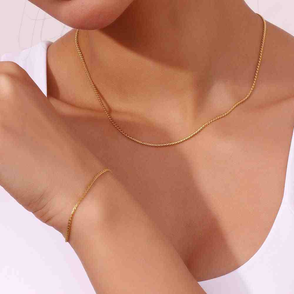 Wearing 18k Gold Plated thin S Chain Bracelet and necklace - Cici. Shop at Mithra and Co.