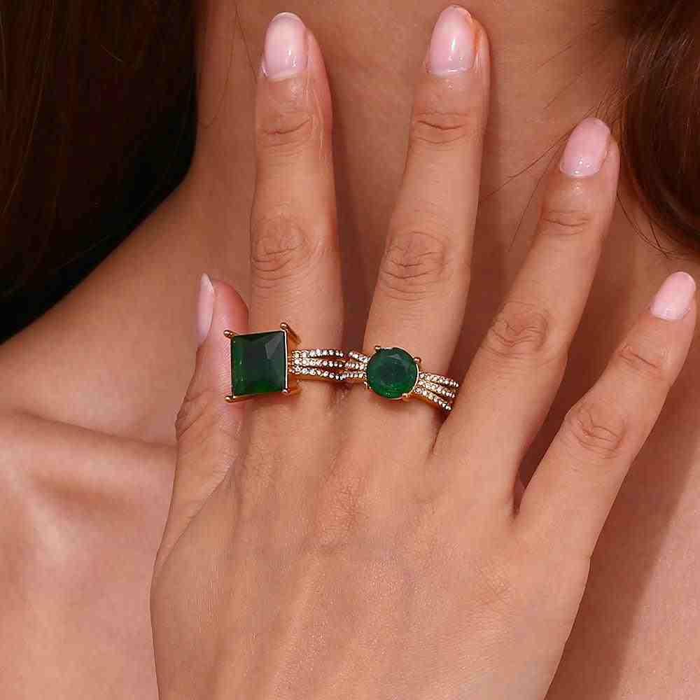 Girl wearing 2 distinct 18k gold plated Green Gemstone Rings in separate fingers.