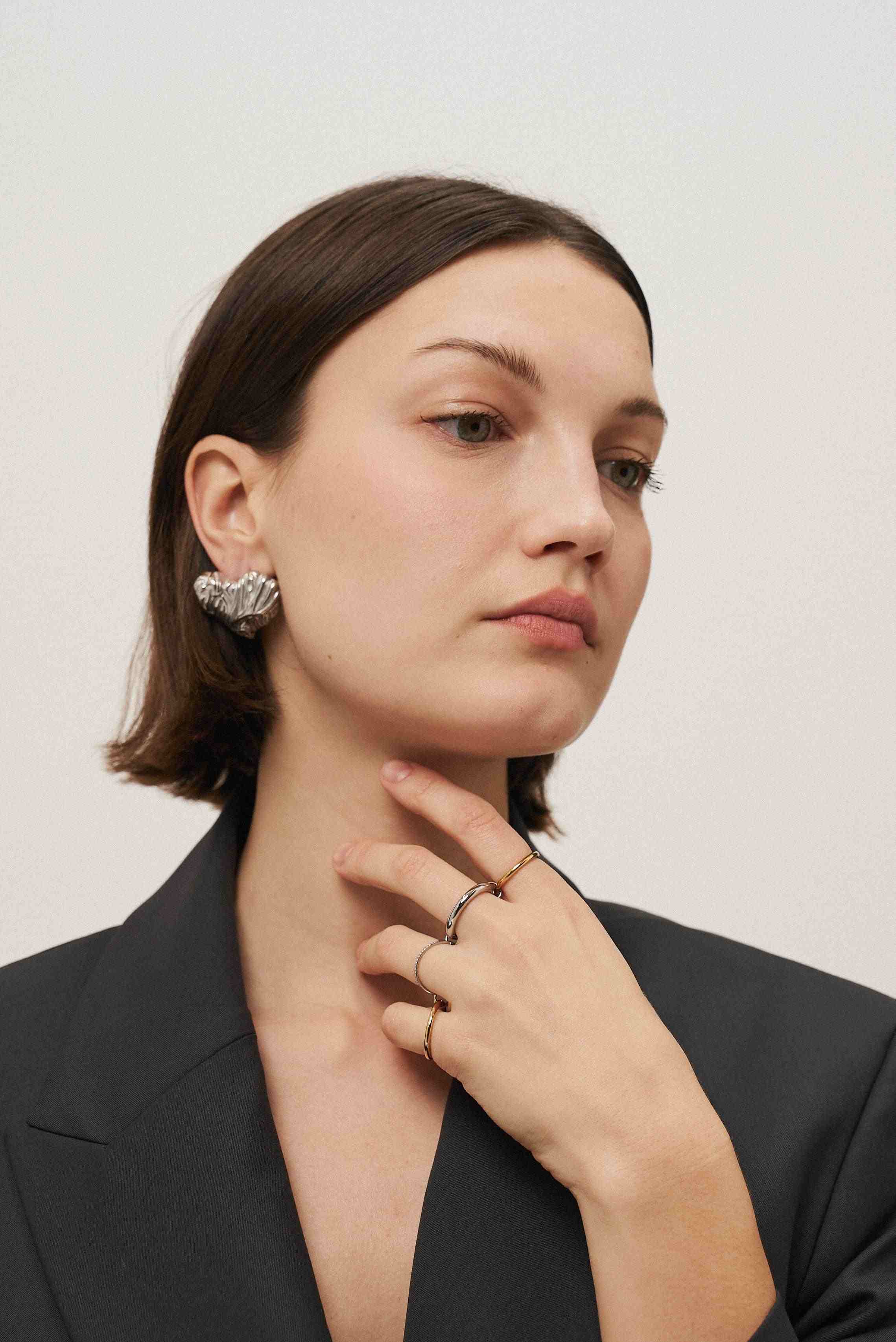 Girl wearing silver Plated heart earrings. Buy at Mithra and Co.