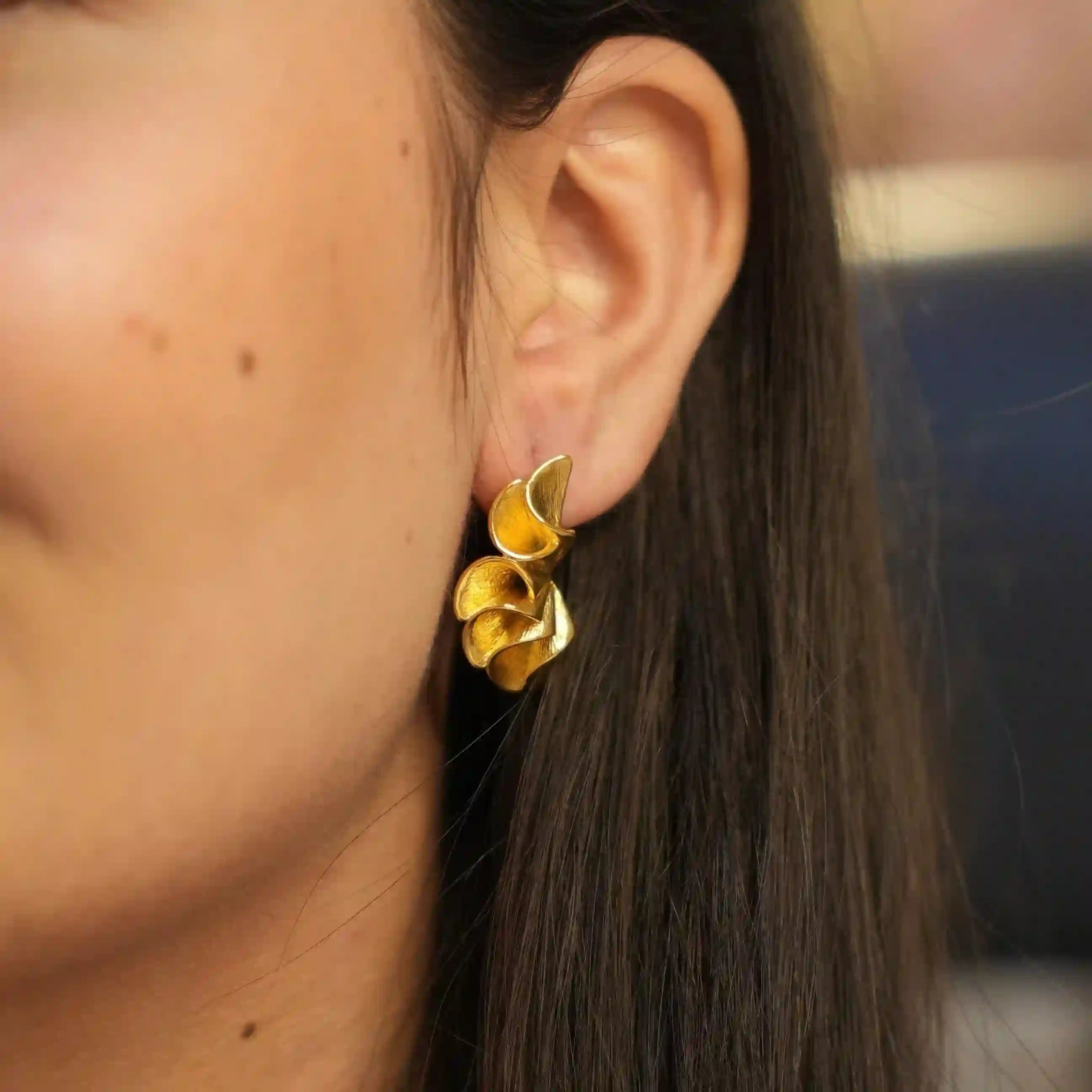 Wearing Flora Earrings 18k gold plated.