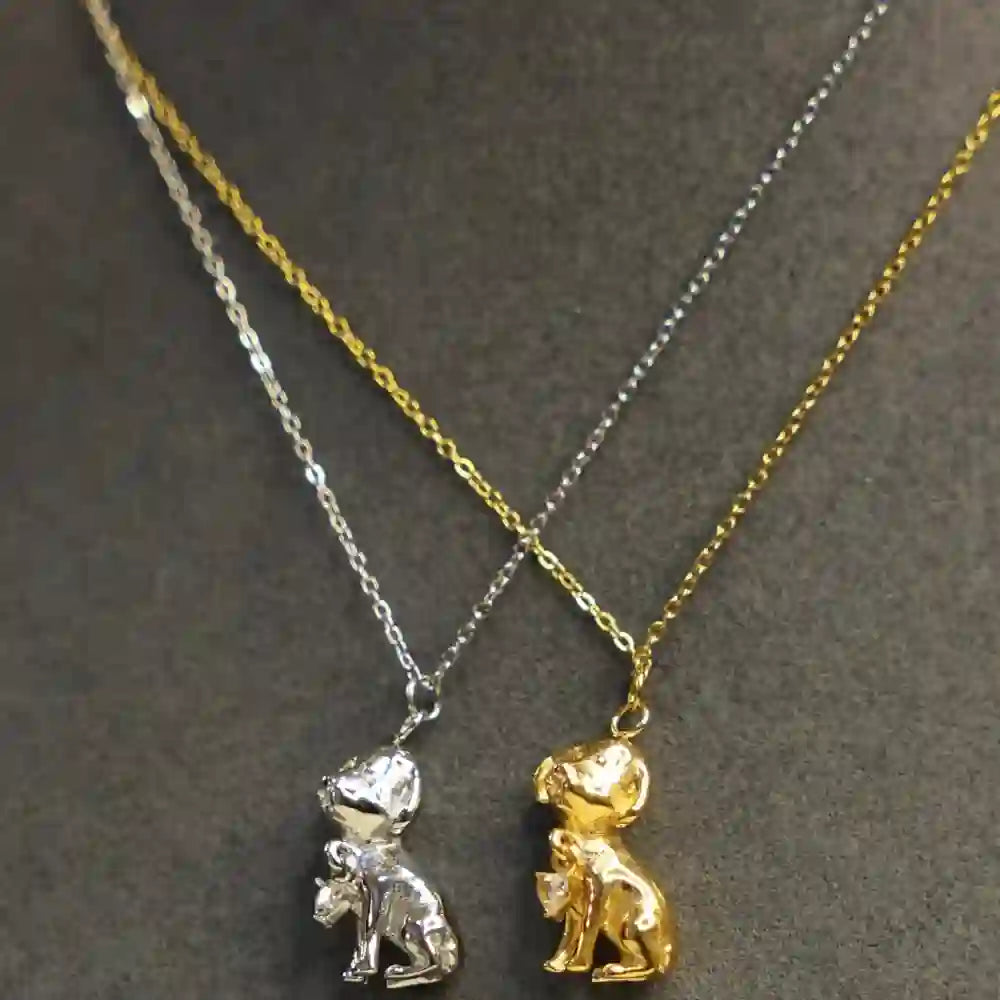 Dum wearing 18k Gold and Silver Plated Puppy Pendant Necklace. Shop at Mithra and Co.