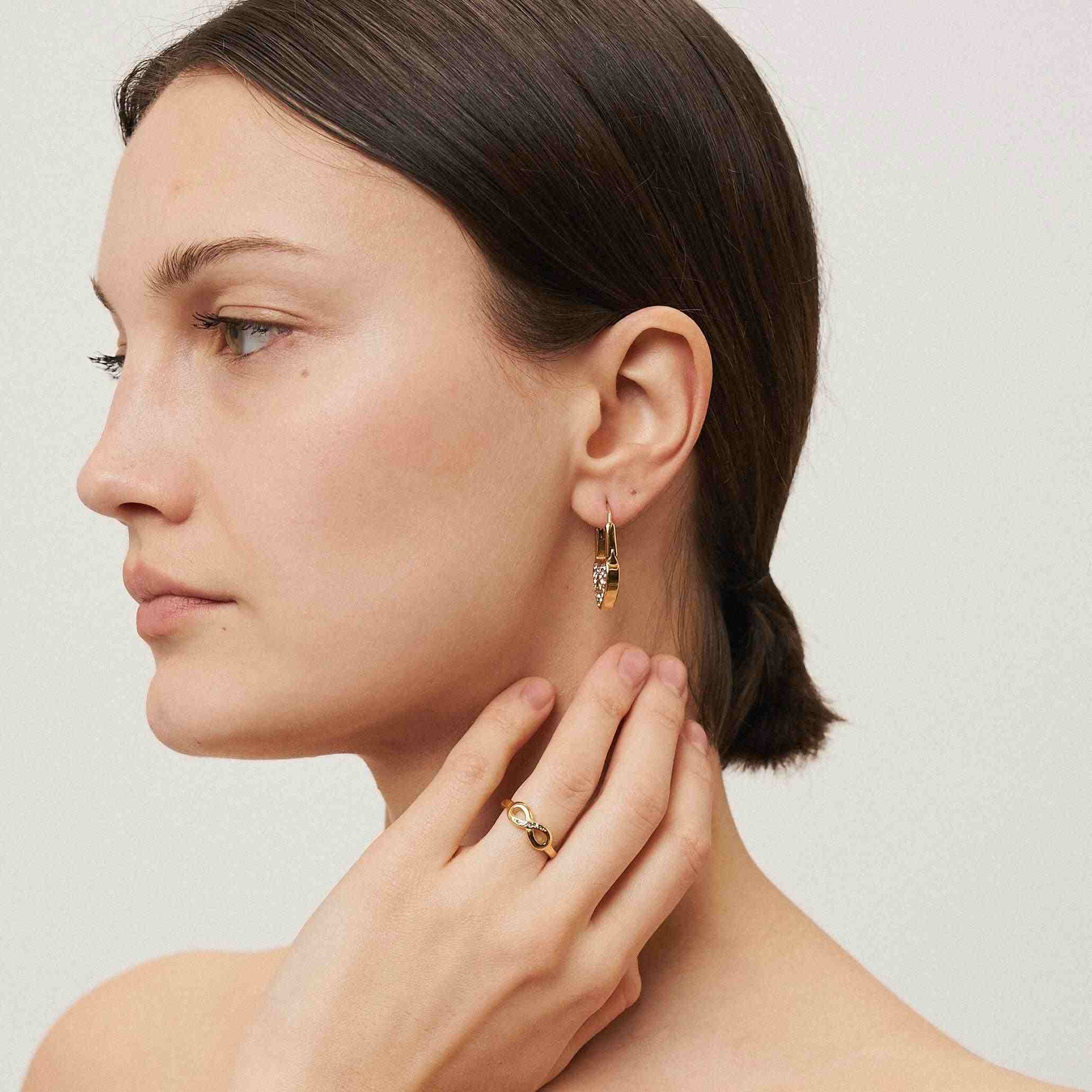 Girl wearing 18k Gold Plated earring and ring. Buy Now at Mithra and Co.