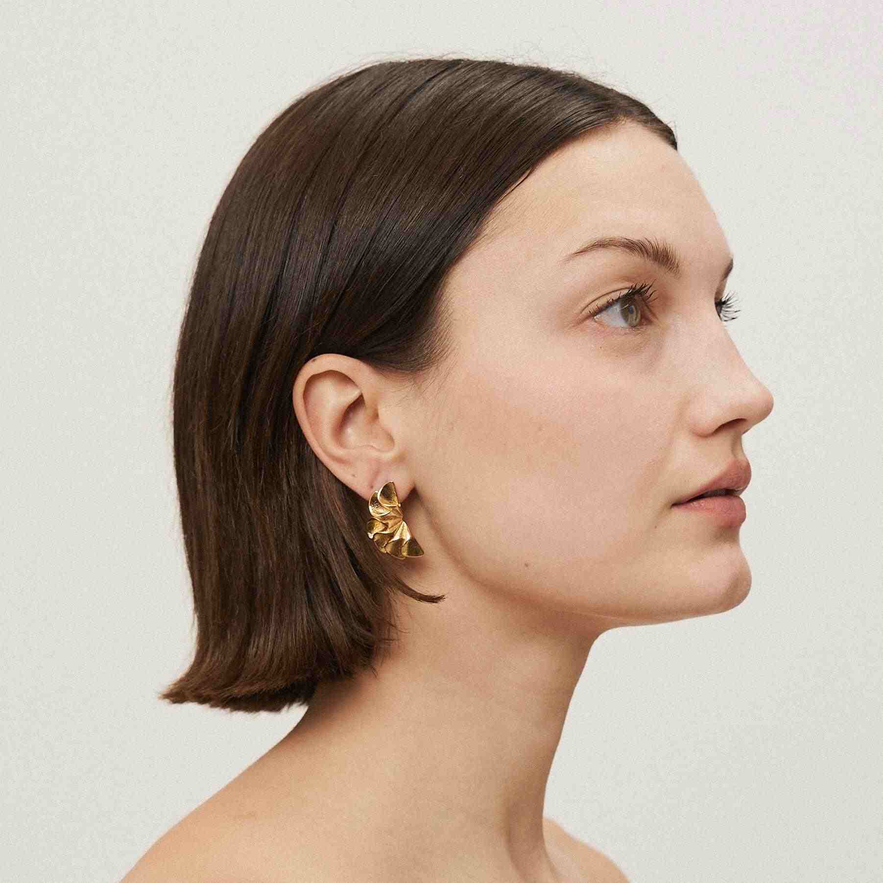 Girl wearing Flora Earrings - 18k Gold Plated Flower Earrings.