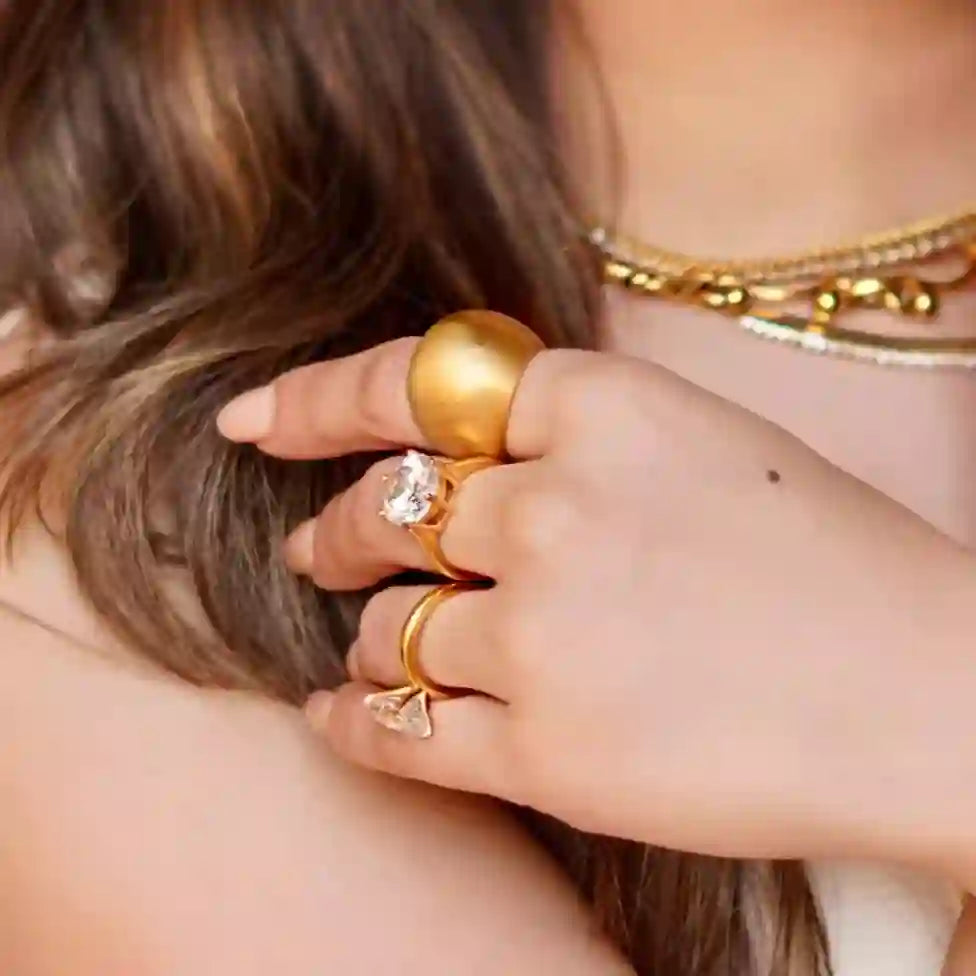Girl wearing a Crown Shape ring in gold plating designed to enchant. Shop at Mithra and Co.