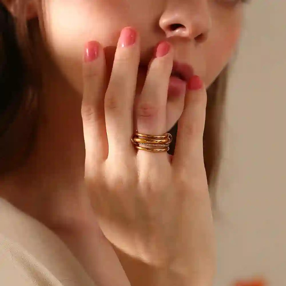 Wearing gold and silver stacking rings. Shop Online.