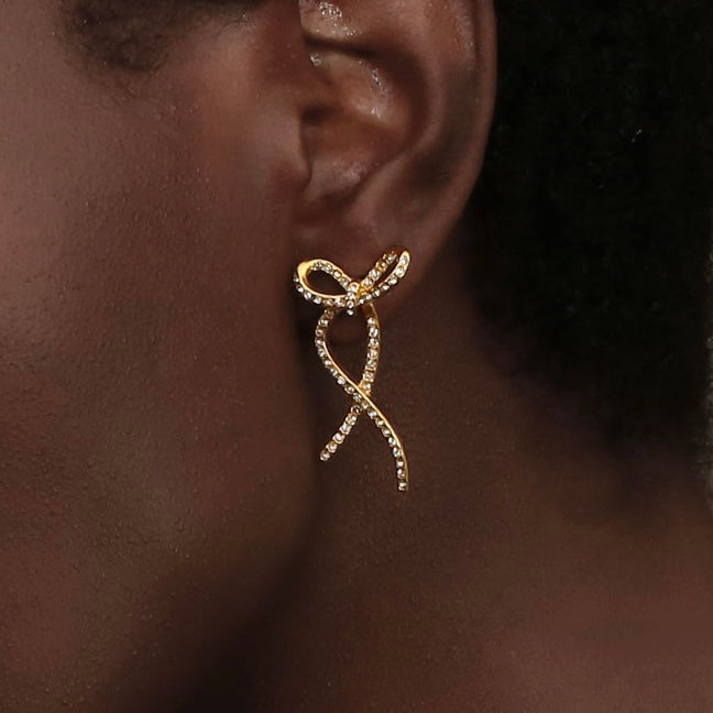 Girl wearing BOwtie Earrings. Sculpted Elegance. Shop at Mithra and Co.