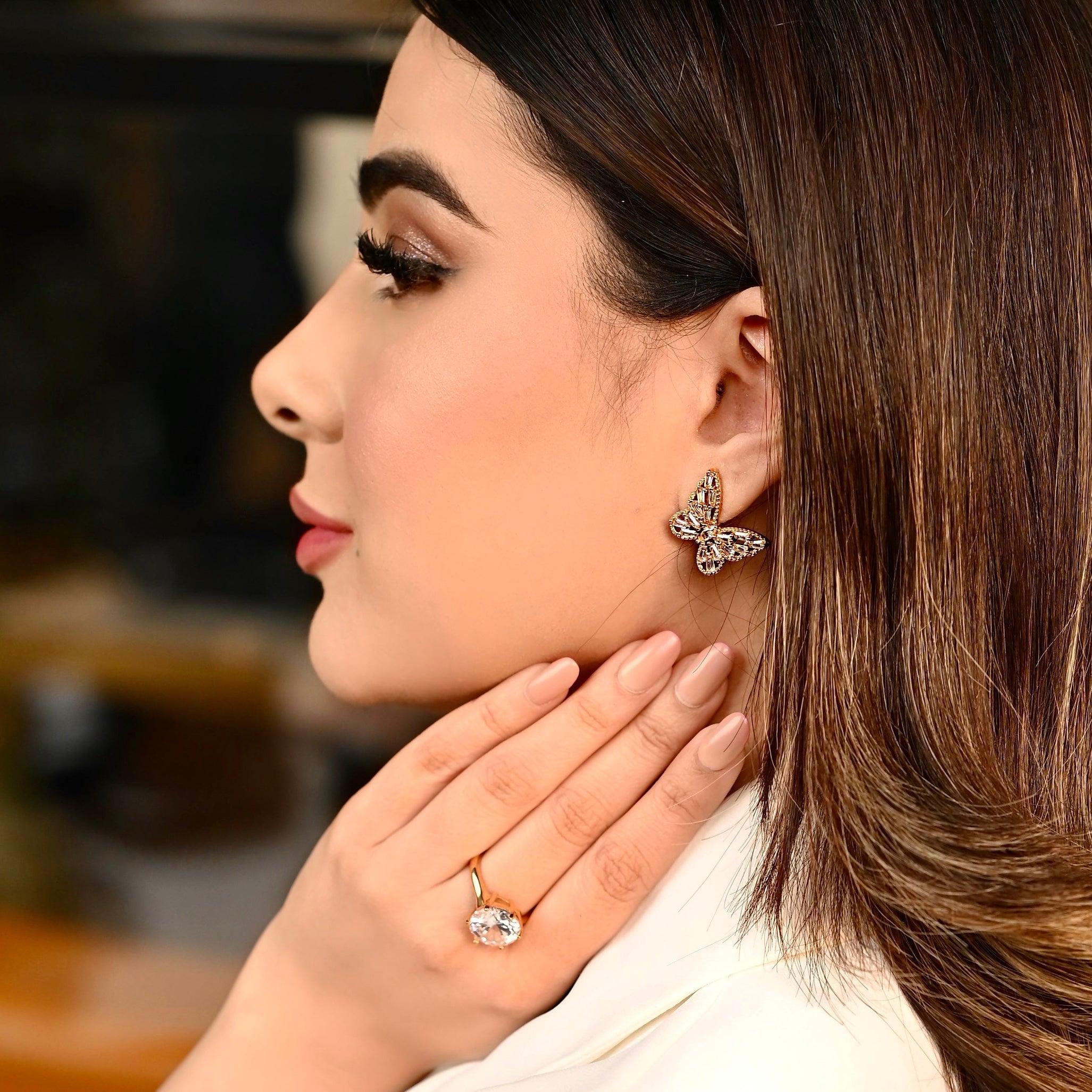 Girl wearing enchanted Flutter - 18k Gold Plated Butterfly Earrings Studs. Shop at Mithra and Co.