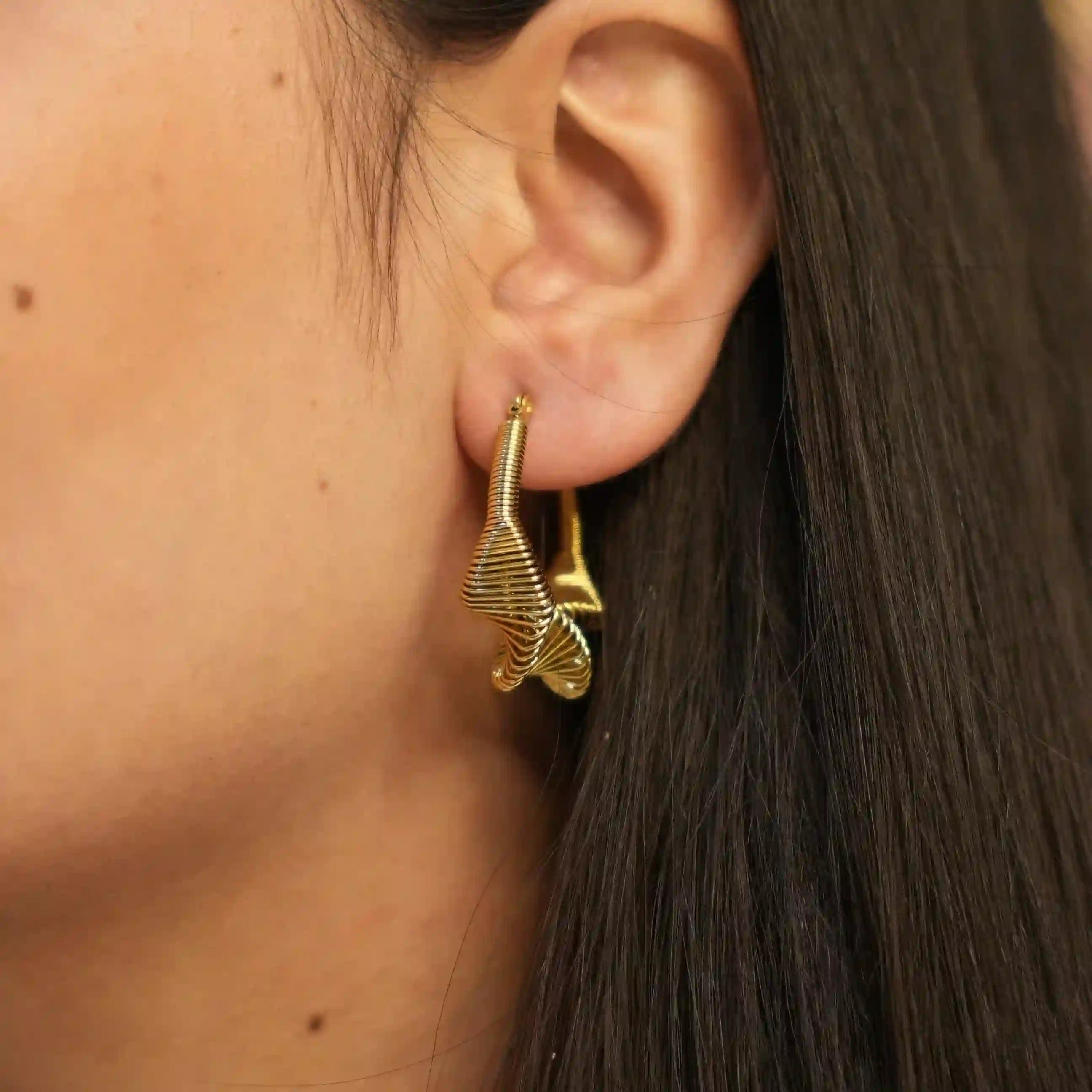 Girl wearing 18k gold Plated Spring Hoop Earrings - Vela. Shop Online at Mithra and Co.