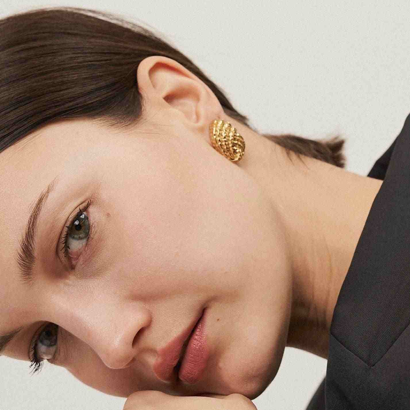 Girl wearing Gold Plated Knot Studs - Knotique Earrings. Shop at Mithra and Co.