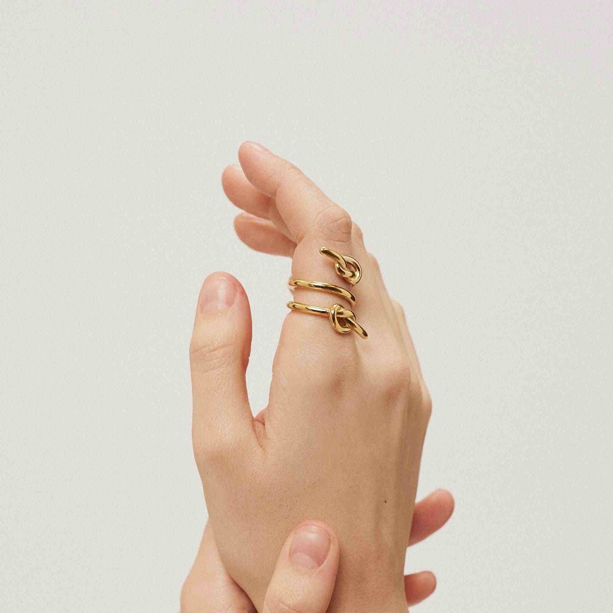 Girl Wearing 18k Gold Plated 3 Layer Spiral Ring With Knot. Buy Online at Mithra and Co.