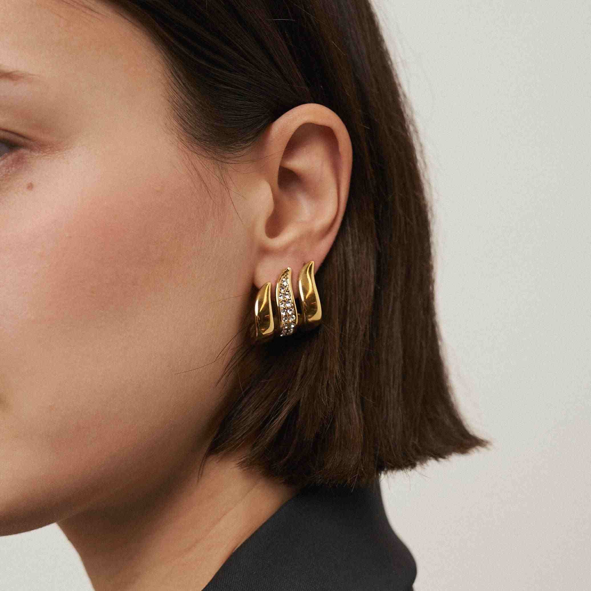 Wearing 18k Gold Plated hoop Earrings. Buy Flame Earrings Online at Mithra and Co.