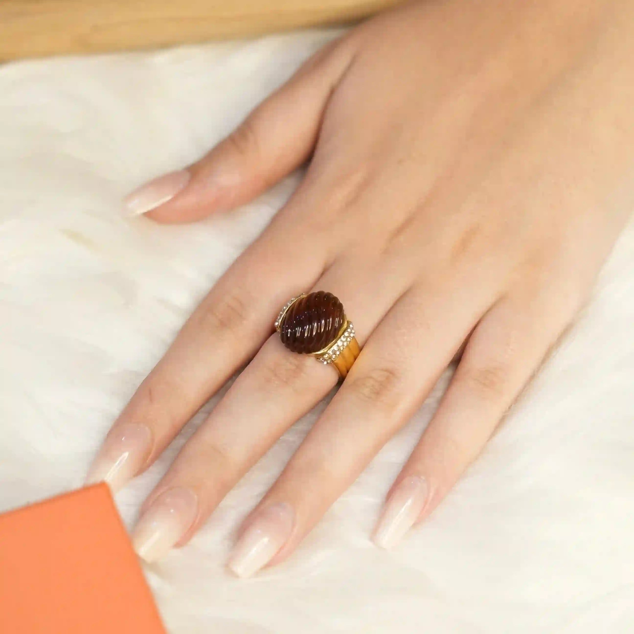 Wearing Luminara Ring- 18k gold plated ring with a red amber stone. Buy Online.