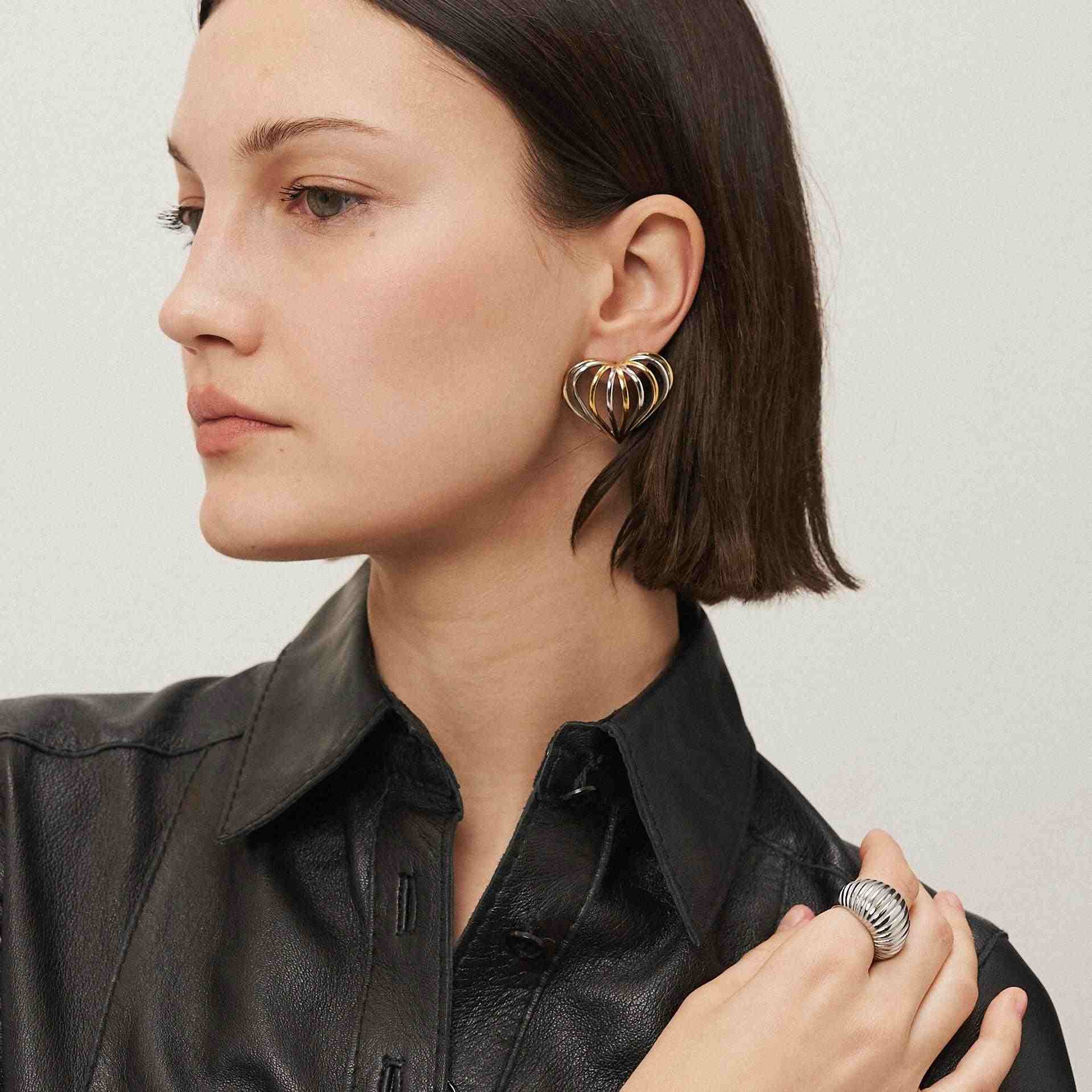Wearing Gold plated Earrings. Shop Heart in a cage Online at Mithra and Co.