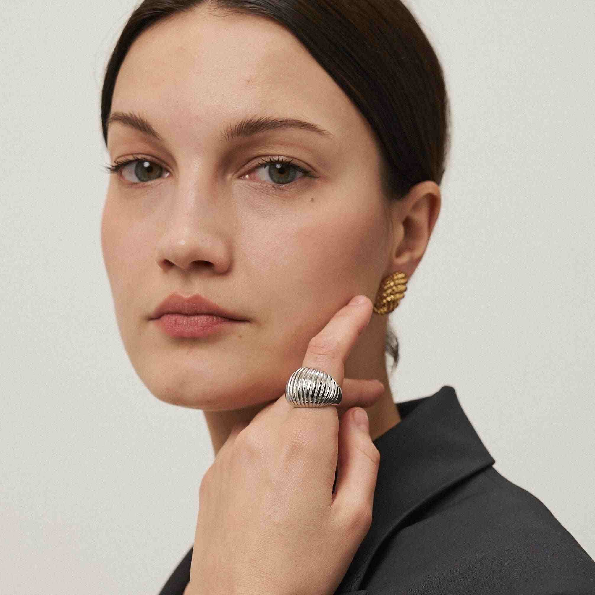 Girl wearing Gold Plated Studs Earrings. Buy Online at Mithra and Co.
