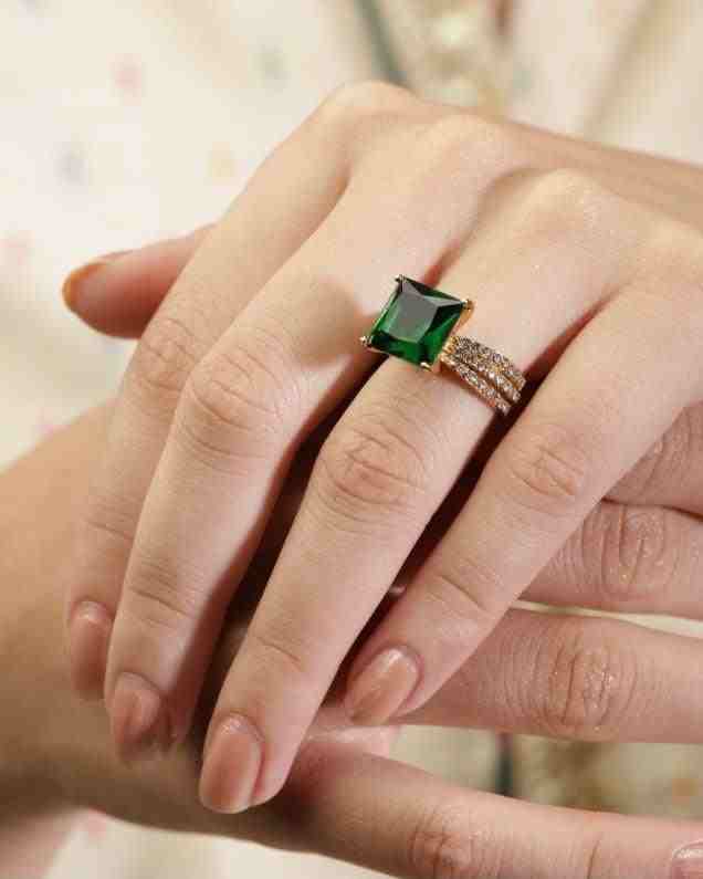 GIrl wearing Gold Square Engagement Ring - Aura. Featuring dot shaped zircons on the band.