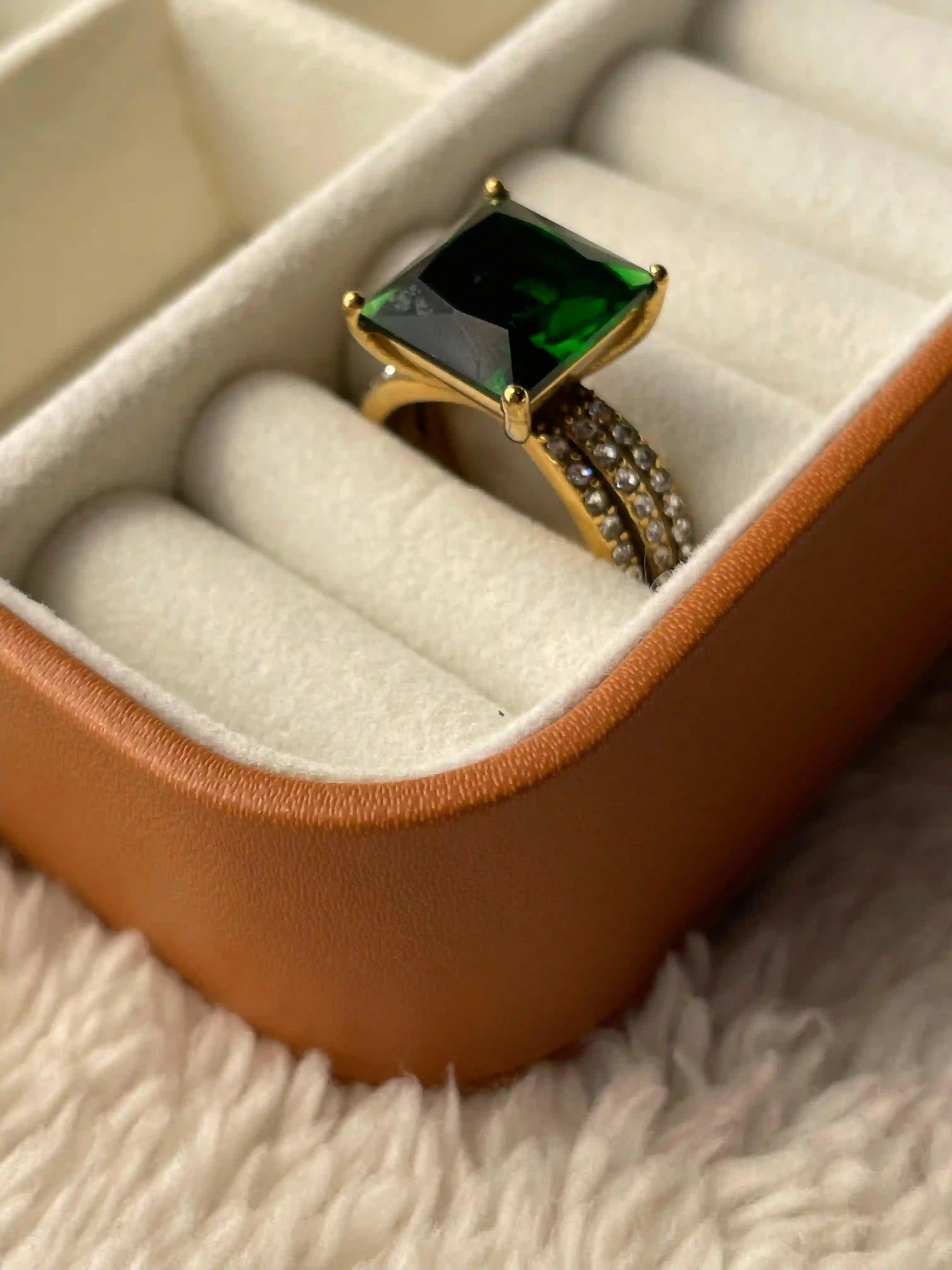 Showcasing Aura Ring in its Box. Dot shaped zircons on 18k gold plated band.